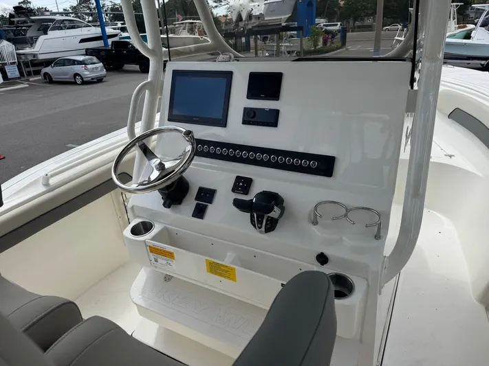  Yacht Photos Pics 2025 Key West 260 boat dashboard with steering wheel, controls, and display screens.