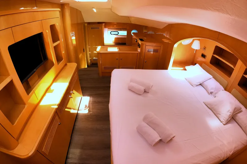 Audaz Yacht Photos Pics Luxurious cabin interior of 2007 Privilege 615 yacht with cozy bed and modern amenities.