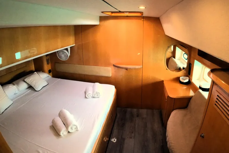 Audaz Yacht Photos Pics Luxurious cabin interior of 2007 Privilege 615 yacht with cozy bed and wooden furnishings.