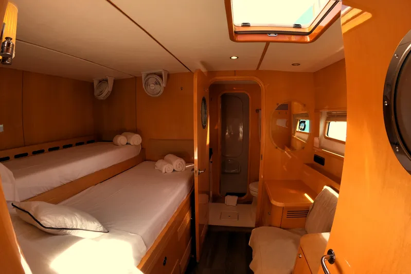 Audaz Yacht Photos Pics Luxurious cabin interior of 2007 Privilege 615 yacht with twin beds and ensuite bathroom.