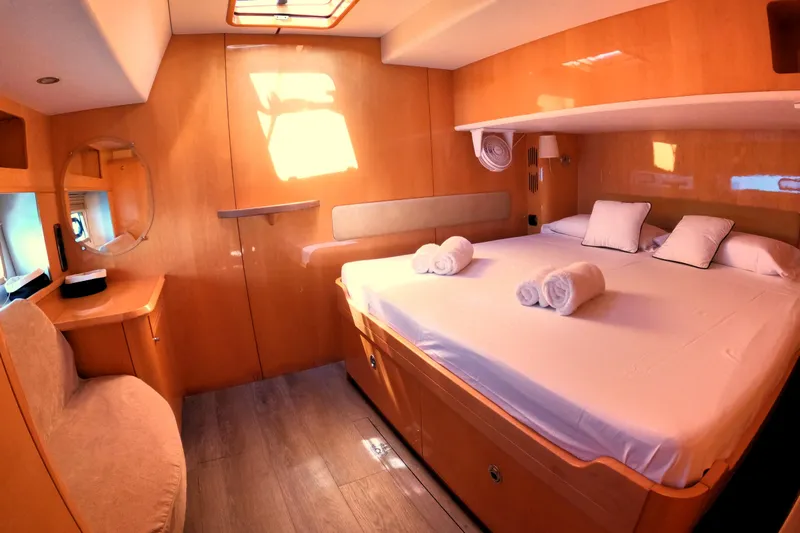 Audaz Yacht Photos Pics Luxurious cabin interior of 2007 Privilege 615 yacht with cozy bed and elegant decor.