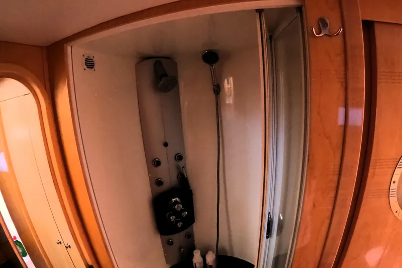 Audaz Yacht Photos Pics Luxury shower area in 2007 Privilege 615 yacht with wooden accents.