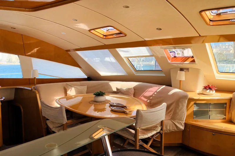 Audaz Yacht Photos Pics Luxurious interior of a 2007 Privilege 615 yacht with elegant seating and panoramic windows.