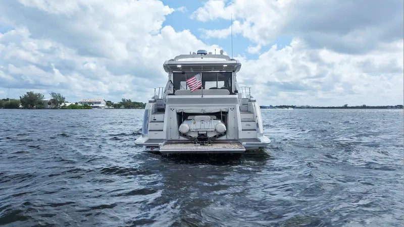 Knot On Call Yacht Photos Pics Azimut 55S 2015 yacht on open water, rear view with American flag.