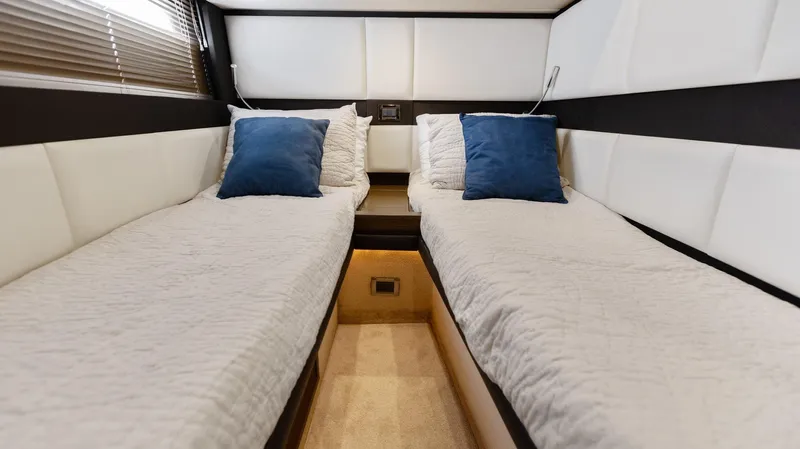 Knot On Call Yacht Photos Pics Luxurious twin cabin in 2015 Azimut 55S yacht with blue accent pillows.