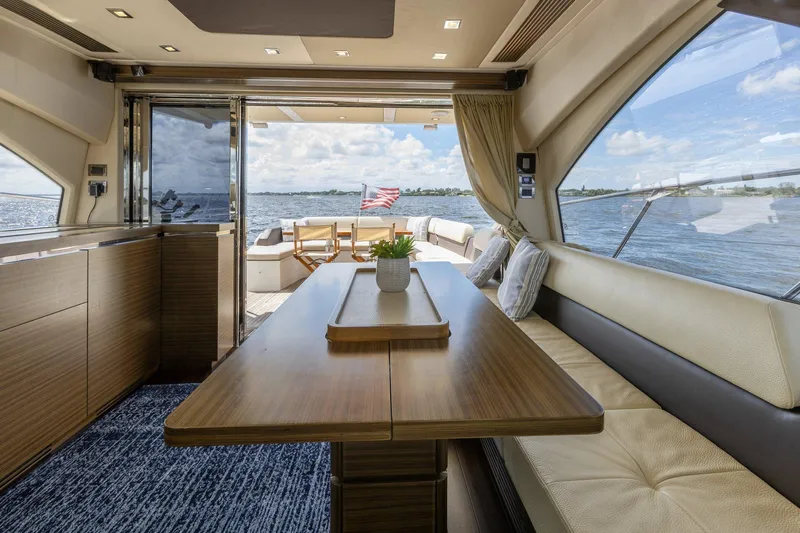 Knot On Call Yacht Photos Pics Luxurious interior of 2015 Azimut 55S yacht with elegant dining area and scenic ocean view.