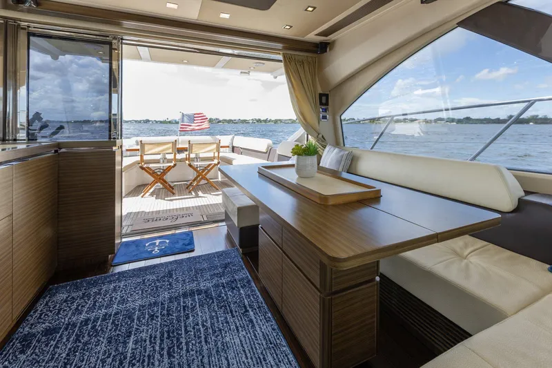 Knot On Call Yacht Photos Pics Luxurious interior of 2015 Azimut 55S yacht with elegant seating and scenic ocean view.