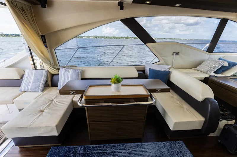 Knot On Call Yacht Photos Pics Luxurious interior of 2015 Azimut 55S yacht with elegant seating and ocean view.