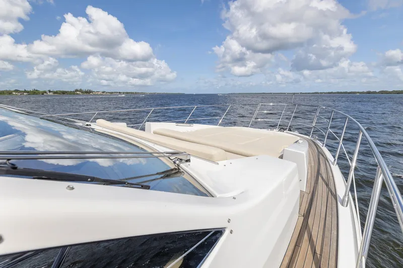 Knot On Call Yacht Photos Pics Azimut 55S 2015 yacht cruising on open water under a clear sky.