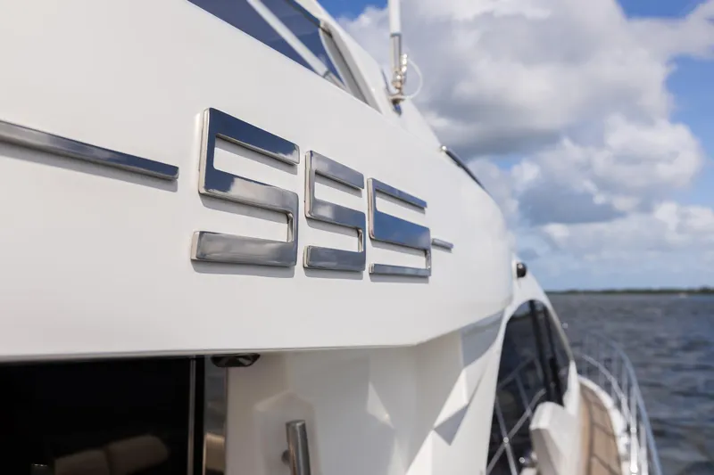 Knot On Call Yacht Photos Pics Azimut 55S yacht, 2015 model, sleek design with ocean backdrop.