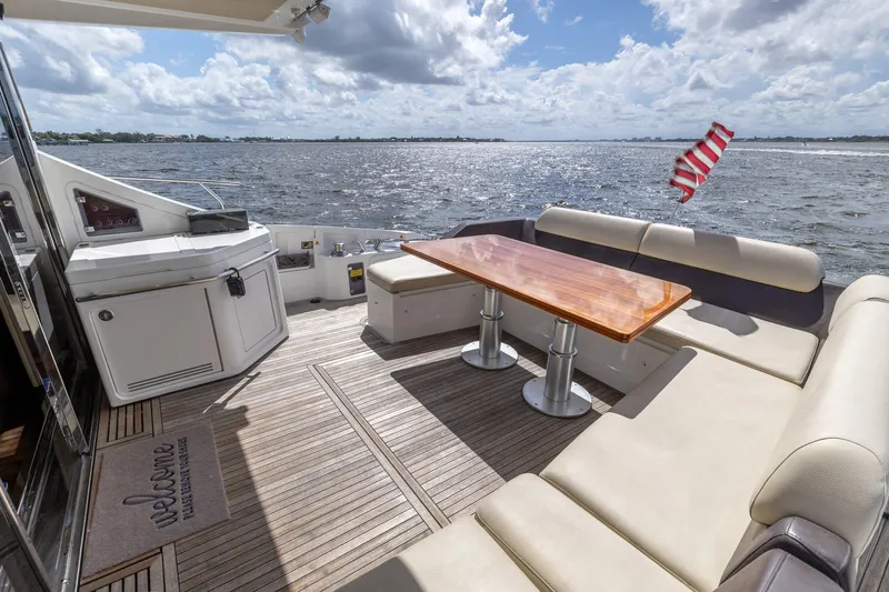 Knot On Call Yacht Photos Pics Luxurious 2015 Azimut 55S yacht deck with seating, table, and ocean view.