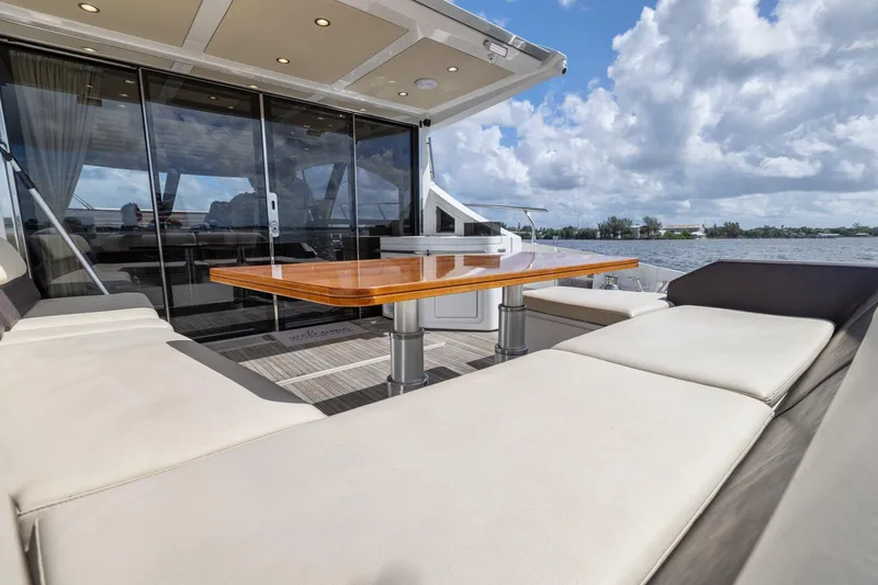 Knot On Call Yacht Photos Pics Azimut 55S 2015 yacht deck with seating and table, overlooking water and sky.