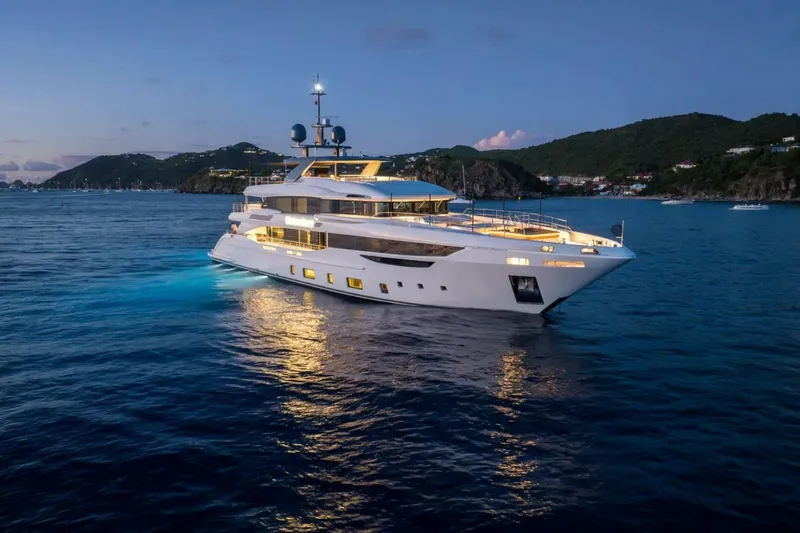 Watercolours Yacht Photos Pics Luxurious 2022 Benetti DIAMOND yacht illuminated at dusk on serene waters.