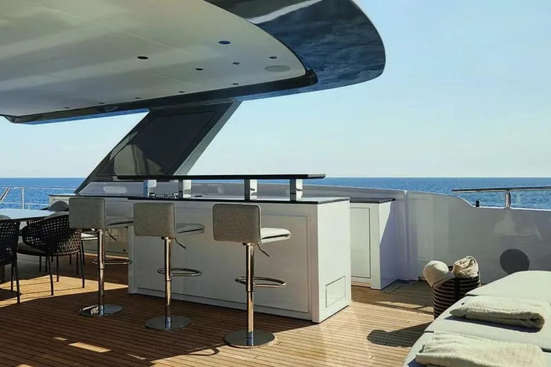 Watercolours Yacht Photos Pics Luxurious 2022 Benetti DIAMOND yacht deck with bar, stools, and ocean view.