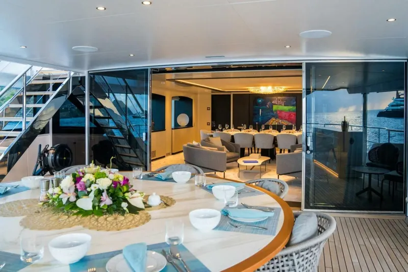 Watercolours Yacht Photos Pics Luxurious 2022 Benetti DIAMOND yacht interior with elegant dining setup and ocean view.