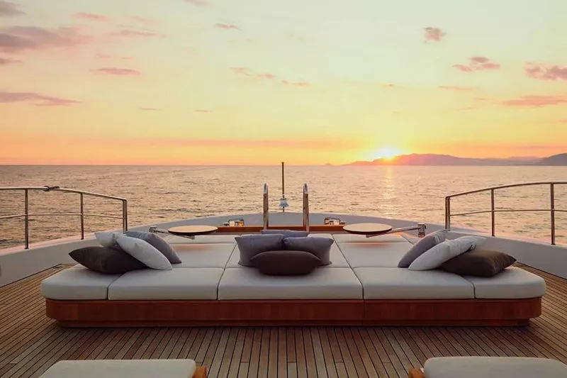 Watercolours Yacht Photos Pics Luxurious 2022 Benetti DIAMOND yacht deck with sunset view over the ocean.