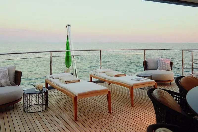 Watercolours Yacht Photos Pics Luxurious 2022 Benetti DIAMOND yacht deck with sun loungers and ocean view.