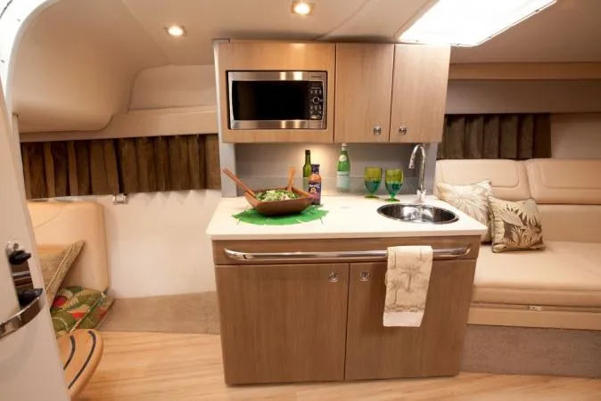 Gratitude Yacht Photos Pics Manufacturer Provided Image: 2015 Formula 350 Sun Sport cabin kitchen with microwave, sink, and dining setup.