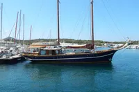Vintage 1944 Custom Schooner 22 m docked in a serene marina setting.