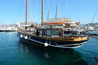 Vintage 1944 Custom Schooner 22 m docked in a marina, surrounded by other boats.