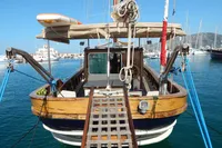 Vintage 1944 Custom Schooner 22 m docked, featuring wooden deck and rigging, in a sunny marina.