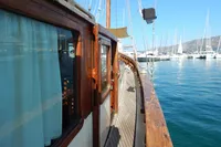 Vintage 1944 Custom Schooner 22 m docked in a marina, showcasing wooden deck and cabin.