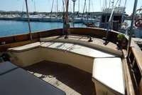 Spacious deck of a 1944 Custom Schooner 22 m, featuring comfortable seating and wooden flooring.