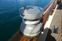Winch on deck of 1944 Custom Schooner 22 m, near blue water.