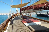 Vintage 1944 Custom Schooner 22 m with wooden deck and sunbathing area, docked in marina.