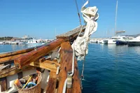 Vintage 1944 Custom Schooner 22 m docked in a marina, with clear blue skies.