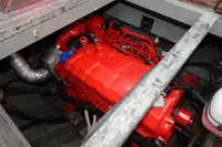 Red engine in a 1944 Custom Schooner 22 m, showcasing detailed mechanical components.