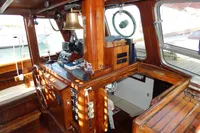Vintage 1944 Custom Schooner 22 m interior with wooden helm, nautical instruments, and brass bell.