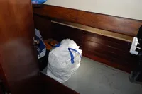 Interior of 1944 Custom Schooner 22 m with wooden bench and storage bag.