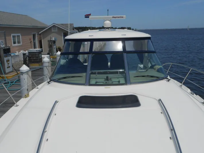  Yacht Photos Pics 2004 Sea Ray 420 Sundancer yacht docked at a marina.