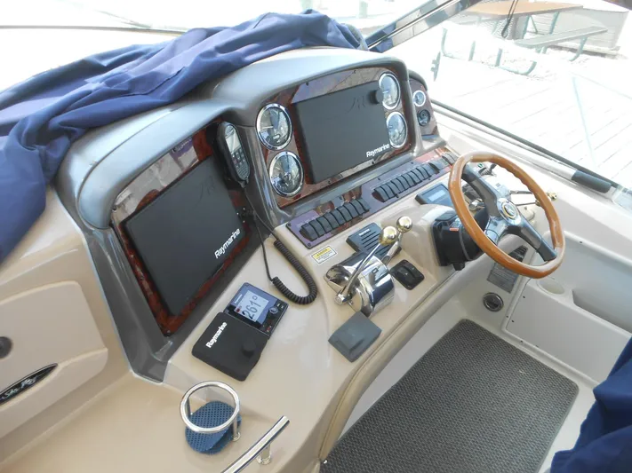  Yacht Photos Pics 2004 Sea Ray 420 Sundancer helm with Raymarine electronics and wooden steering wheel.