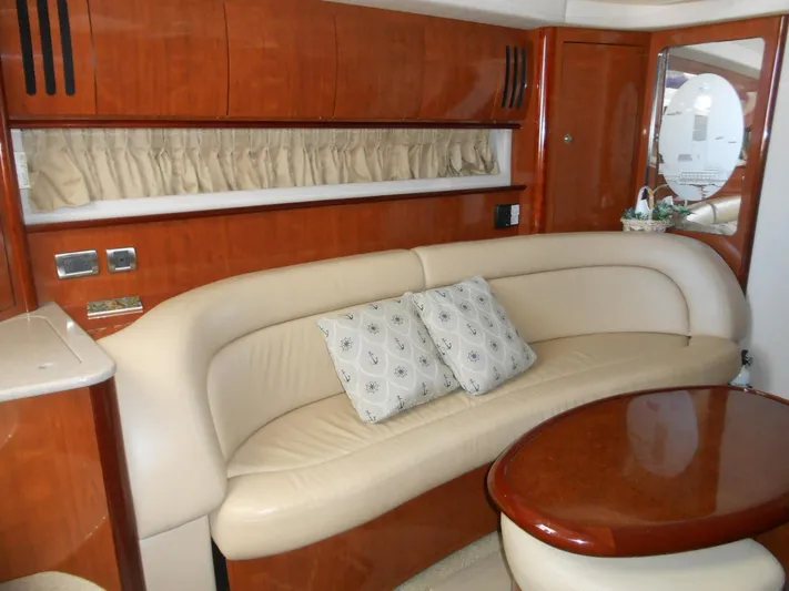  Yacht Photos Pics Luxurious interior of a 2004 Sea Ray 420 Sundancer yacht with leather seating and wooden finishes.