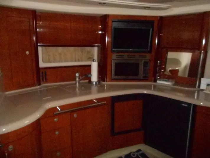  Yacht Photos Pics 2004 Sea Ray 420 Sundancer yacht kitchen with wood cabinetry and modern appliances.