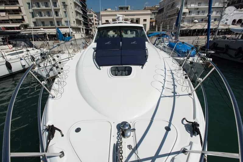  Yacht Photos Pics 2007 Sea Ray 515 Sundancer yacht docked in a marina, surrounded by buildings.