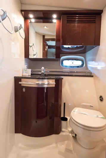  Yacht Photos Pics Luxurious bathroom in 2007 Sea Ray 515 Sundancer yacht with modern fixtures and elegant wood cabinetry.