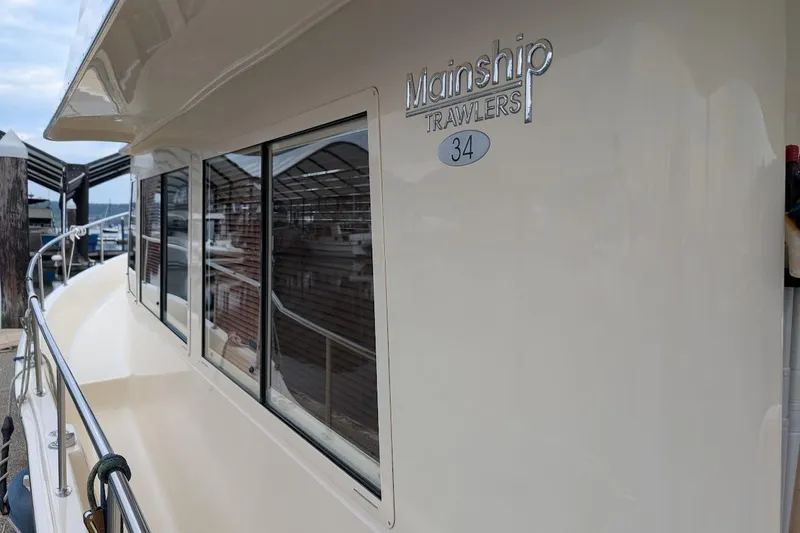 Lulu Jack Yacht Photos Pics 2008 Mainship 38 yacht side view with windows and railing at dock.