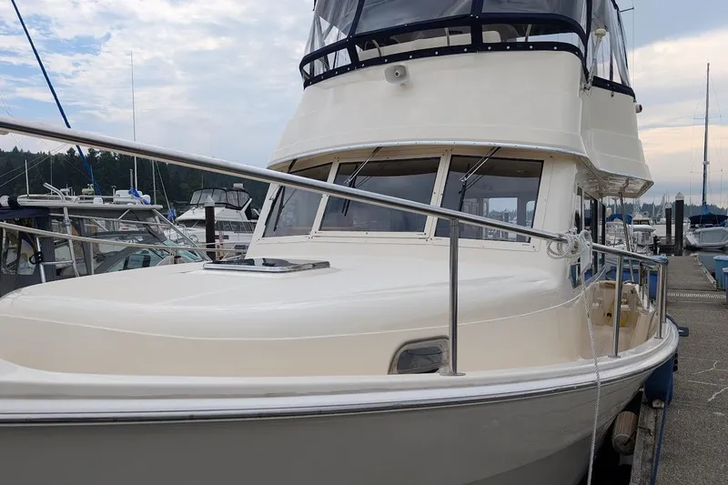 Lulu Jack Yacht Photos Pics 2008 Mainship 38 yacht docked at marina under cloudy sky.