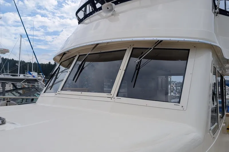 Lulu Jack Yacht Photos Pics 2008 Mainship 38 yacht with sleek windows and wipers, docked at a marina.