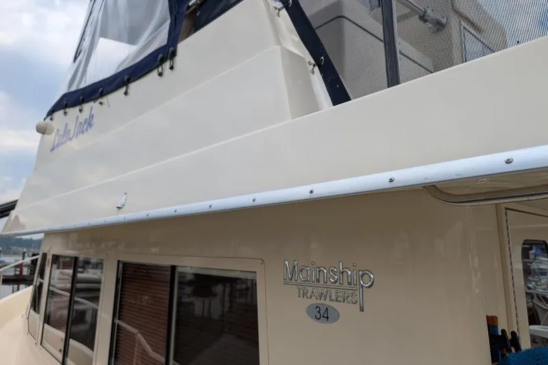 Lulu Jack Yacht Photos Pics 2008 Mainship 38 boat with "Mainship Trawlers 34" emblem, docked at marina.