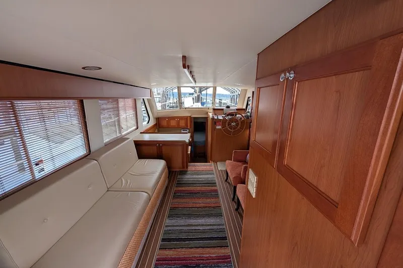 Lulu Jack Yacht Photos Pics Interior of 2008 Mainship 38 yacht with wood paneling and striped rug.