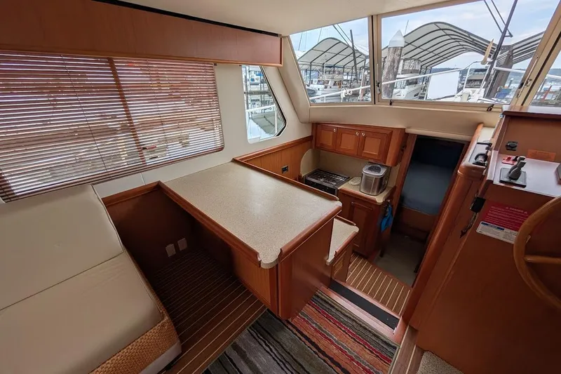 Lulu Jack Yacht Photos Pics Interior of 2008 Mainship 38 yacht with kitchen, seating, and large windows.