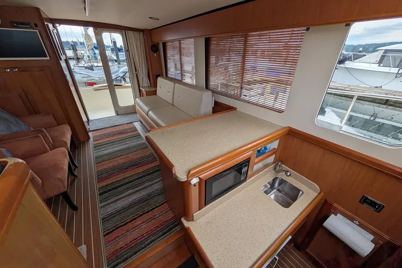 Lulu Jack Yacht Photos Pics Interior of a 2008 Mainship 38 yacht with modern kitchen and seating area.