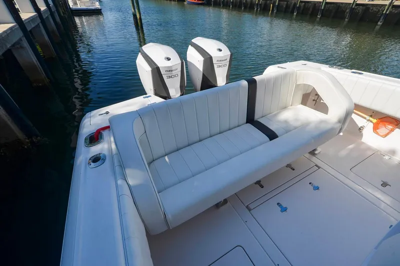 Quid Pro Quo Yacht Photos Pics 2013 Intrepid 300 Center Console boat with dual Evinrude engines, docked in a marina.