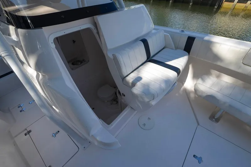 Quid Pro Quo Yacht Photos Pics 2013 Intrepid 300 Center Console boat interior with seating and open compartment.