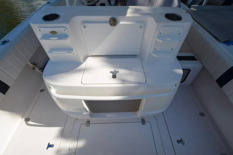 Quid Pro Quo Yacht Photos Pics 2013 Intrepid 300 Center Console boat interior with storage compartments and seating.