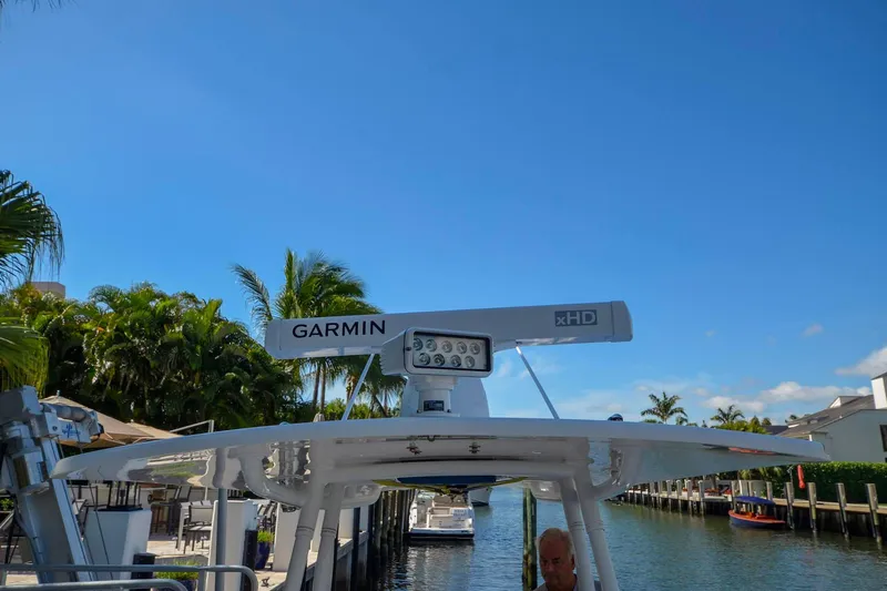 Quid Pro Quo Yacht Photos Pics 2013 Intrepid 300 Center Console with Garmin radar, docked near palm trees.